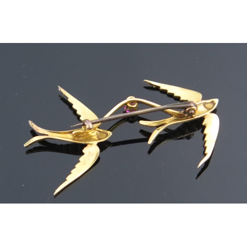 79 - A Twin Swallow Brooch linked by a pink spinel and mounted with untested pearls in an unmarked high c... 