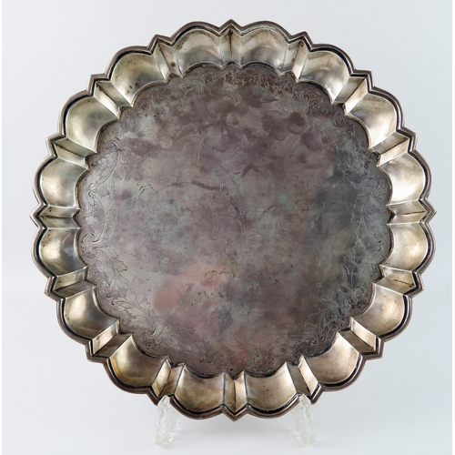 A large continental silver dish, unmarked. of circular outline with lobed wavy edge border, with floral band decoration, 34.5cm diameter, 1010gms, 32.47ozs
