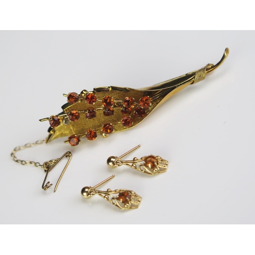 85 - An 18ct Gold and Citrine? Foliate Spray Brooch, 70mm, 13.6g and a pair of similar yellow metal earri... 