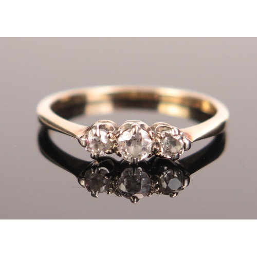 89 - A Three Stone Diamond Ring in an unmarked high carat gold setting, largest stone c. 3.5mm, size P.5,... 