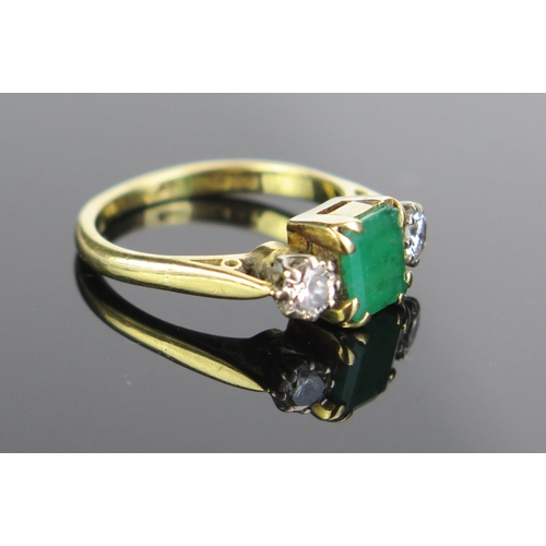 98 - A Modern 18ct Gold, Emerald and Diamond Three Stone Ring,  c. 6.9x5.8mm emerald and 4mm brilliant ro... 