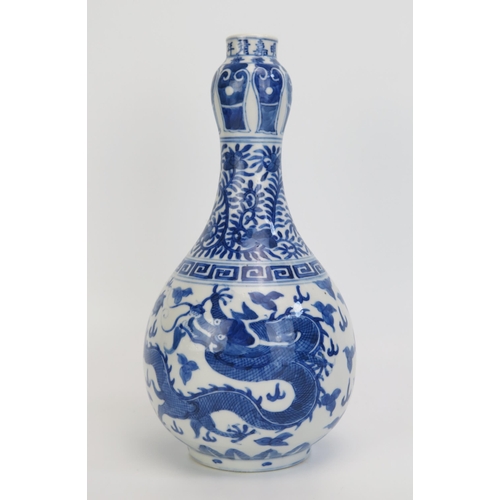 1442 - A 18th century Chinese blue and white vase decorated with dragons to the bulbous body, foliate work ... 