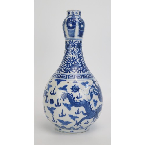 1442 - A 18th century Chinese blue and white vase decorated with dragons to the bulbous body, foliate work ... 