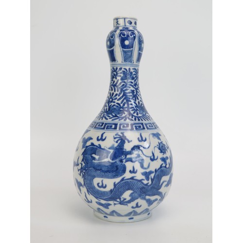 1442 - A 18th century Chinese blue and white vase decorated with dragons to the bulbous body, foliate work ... 