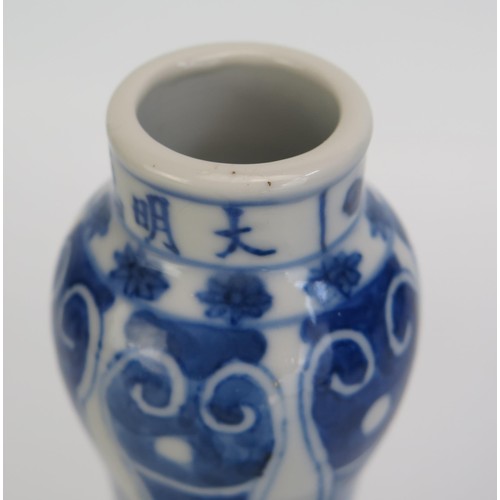 1442 - A 18th century Chinese blue and white vase decorated with dragons to the bulbous body, foliate work ... 