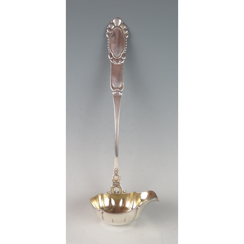 32 - A large continental silver soup ladle, having an oval lipped bowl with gilded interior, 35cm long, 2... 