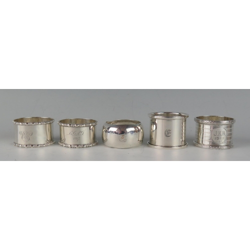 63 - A collection of five assorted silver napkin rings, various makers and dates, total weight of silver,... 