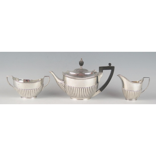 66 - A matched George V silver three-piece bachelors tea service, various makers and dates, of oval outli... 