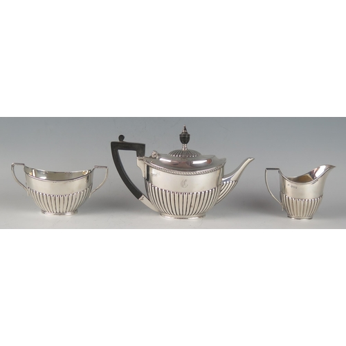 66 - A matched George V silver three-piece bachelors tea service, various makers and dates, of oval outli... 