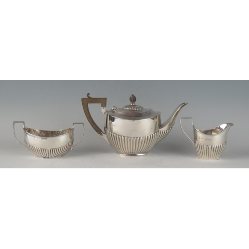 67 - A matched George V silver three-piece bachelors tea service, various makers and dates, of oval outli... 