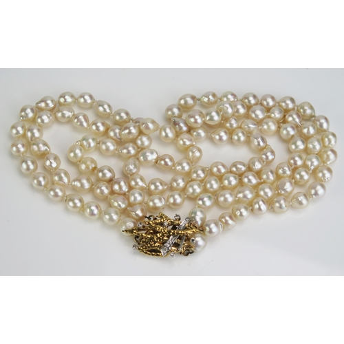 102 - A Twin Strand untested Pearl Necklace with a diamond clasp in an 18ct white and yellow gold setting ... 