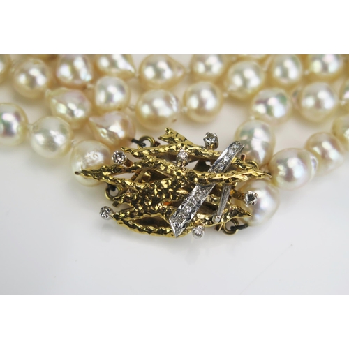 102 - A Twin Strand untested Pearl Necklace with a diamond clasp in an 18ct white and yellow gold setting ... 