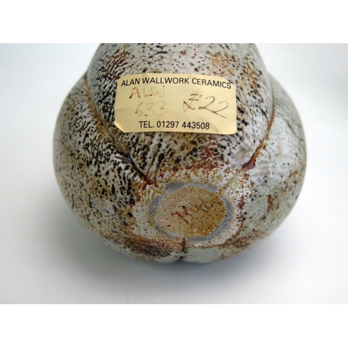 1080 - Alan Wallwork, a stoneware seed pod vase, bears paper studio label, 13cm high, together with another... 