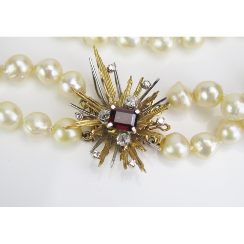 109 - A Twin Strand untested Pearl Choker with 18ct gold, diamond and red tourmaline? clasp, 9x7mm red sto... 