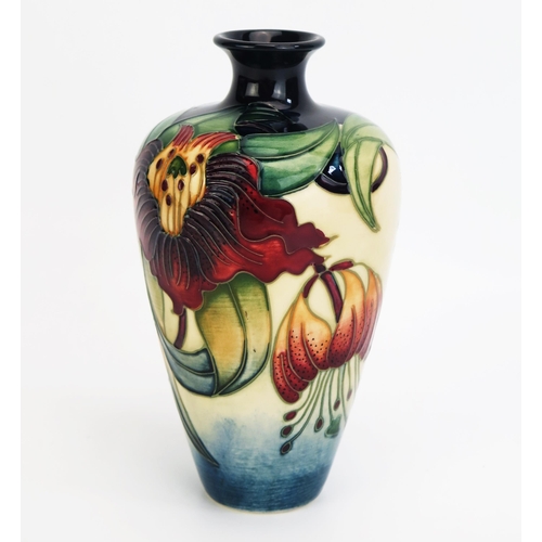 1094 - A Moorcroft pottery vase with 'Anna Lily' decoration by Nicola Slaney, released in 2000, 16cm high,