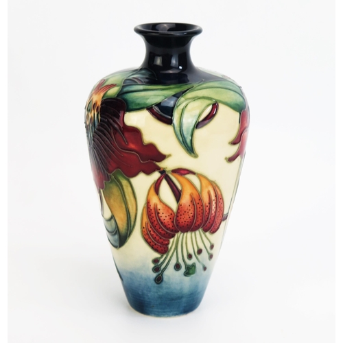 1094 - A Moorcroft pottery vase with 'Anna Lily' decoration by Nicola Slaney, released in 2000, 16cm high,