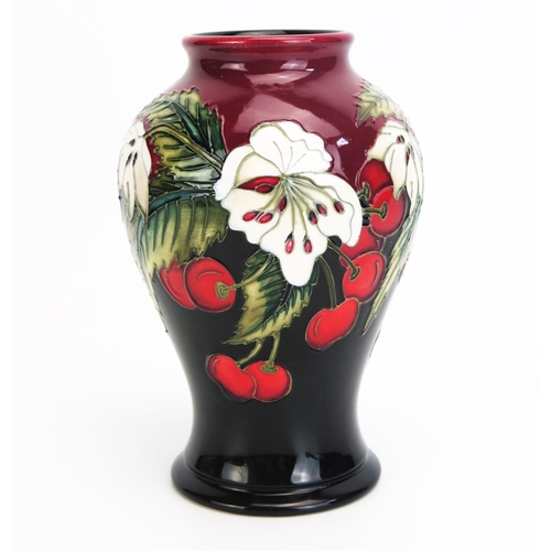 1104 - A Moorcroft pottery vase with 'Cherry Blossom' decoration designed by Nicola Slaney, released in 201... 