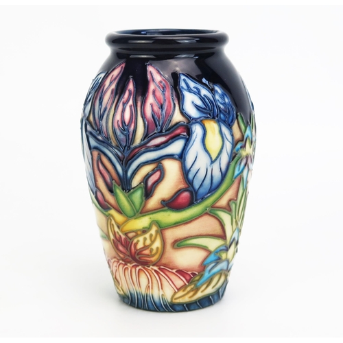 1110 - A Moorcroft pottery vase with 'Geneva' pattern decoration designed by Philip Gibson, released in 200... 