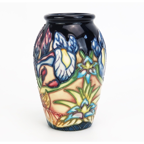 1110 - A Moorcroft pottery vase with 'Geneva' pattern decoration designed by Philip Gibson, released in 200... 