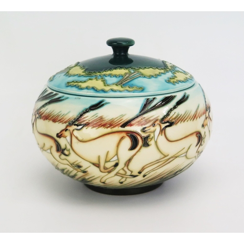 1115 - A Moorcroft pottery pot and cover with 'Impala' decoration designed by Kerry Goodwin, released in 20... 