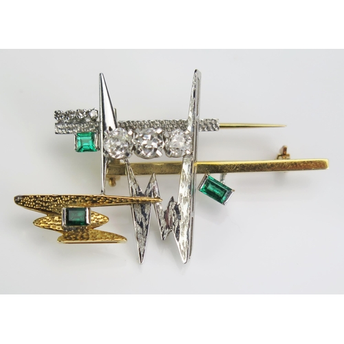 112 - An Emerald and Diamond Brooch in an 18ct yellow and white gold setting, three c. 5mm cushion cut dia...