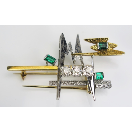 112 - An Emerald and Diamond Brooch in an 18ct yellow and white gold setting, three c. 5mm cushion cut dia... 