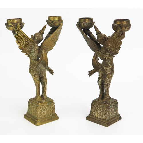 1153 - A pair of Thai cast brass twin branch incense burners in the form of Garuda, in traditional costume,... 