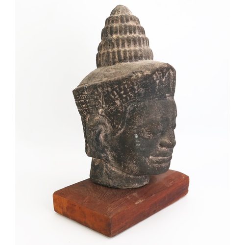 1154 - A Burmese reconstituted stone head of Buddha, mounted on a polished wood stand, overall height 42cm ... 