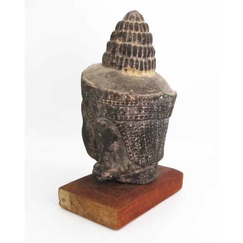 1154 - A Burmese reconstituted stone head of Buddha, mounted on a polished wood stand, overall height 42cm ... 