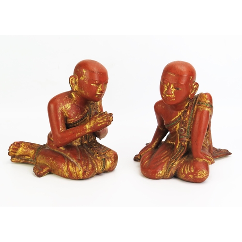 1156 - Two Southeast Asian carved wood , gilt and paste set figures of praying and crouching monks, dressed... 