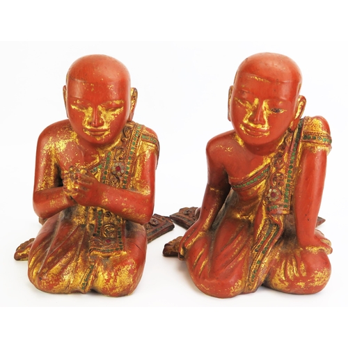 1156 - Two Southeast Asian carved wood , gilt and paste set figures of praying and crouching monks, dressed... 