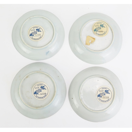 1167 - Four Chinese blue and white saucers from the Nanking cargo, each bearing Christies sale labels to th... 