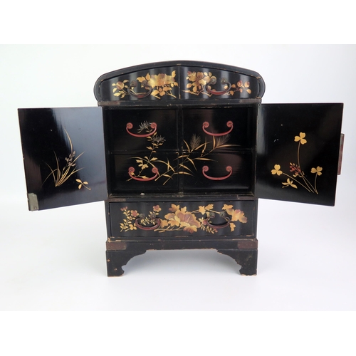 1183 - A Japanese lacquered ware kodansu of arched outline, decorated all over with birds amongst foliage, ... 