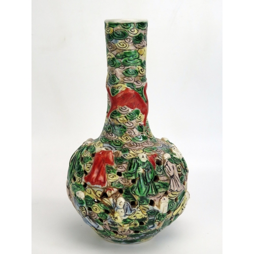 1187 - A Cantonese export porcelain bottle vase, with slender neck and pierced bulbous body decorated in lo... 