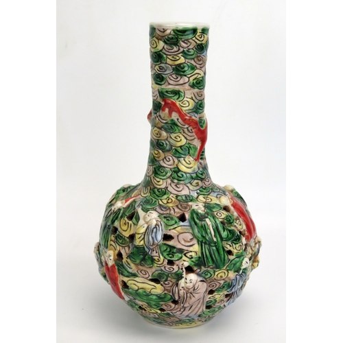 1187 - A Cantonese export porcelain bottle vase, with slender neck and pierced bulbous body decorated in lo... 