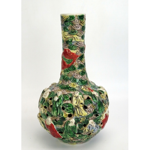 1187 - A Cantonese export porcelain bottle vase, with slender neck and pierced bulbous body decorated in lo... 