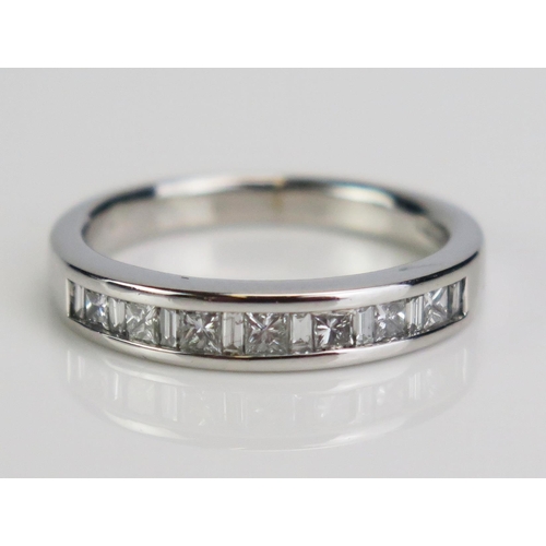 127 - An 18ct White Gold and Diamond Half Eternity Ring channel set with seven c. 22mm princess cut diamon... 