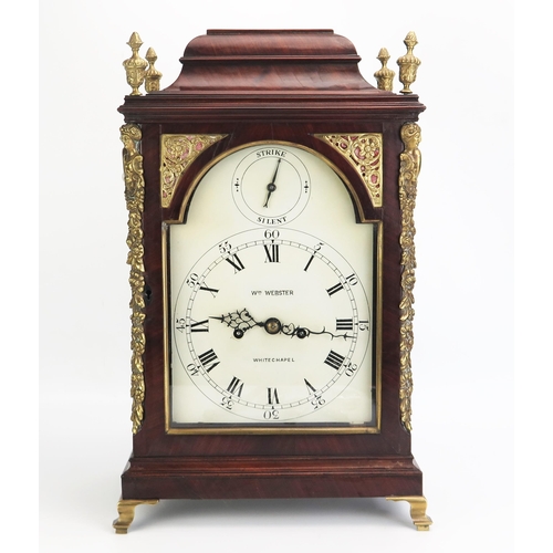 William Webster, Whitechapel, a mahogany cased bracket clock. with caddy top with four brass urn and pineapple finials, with arched glazed panel door, gilt brass caryatids to canted angles, on a plinth base and brass bracket feet, Roman dial with Arabic minutes marks, signed Wm Webster, Whitechapel, and strike silent to the arch, the twin fusee eight day movement with rare Sully escapement striking the hours to a bell. having a foliate and scroll engraved back plate, 49cm high.