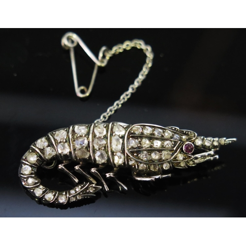 142 - A Rose Cut Diamond and Cabochon Ruby Brooch in the form of a shrimp and in an unmarked precious whit... 