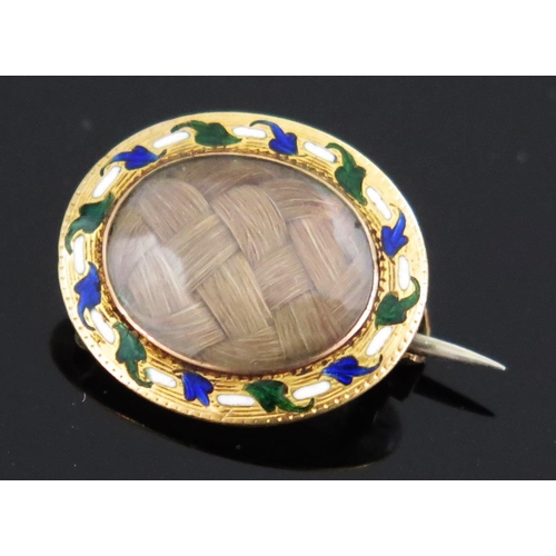 143 - A Georgian Gold and Enamel Oval Memorial Brooch with a central glazed panel set with woven hair, KEE... 