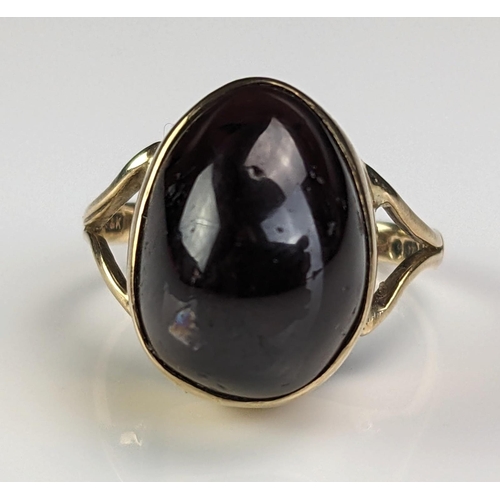3 - A 9ct Gold and Cabochon Garnet Dress Ring, the oval stone 15x11x8.5mm, modern hallmarks, size M, 5.6... 