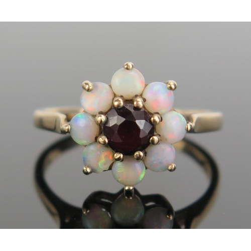 307 - A 9ct Gold, Garnet and Opal Cluster Ring, 12.5mm head, hallmarked, size N.5, c. 2.69g