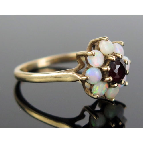 307 - A 9ct Gold, Garnet and Opal Cluster Ring, 12.5mm head, hallmarked, size N.5, c. 2.69g