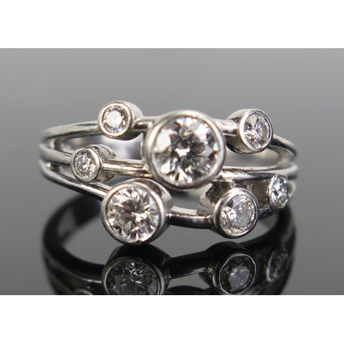 324 - A Platinum and Diamond Seven Stone Ring in rub over settings, largest stone c. 4.8mm, 4mm, 3mm, 2.5m... 