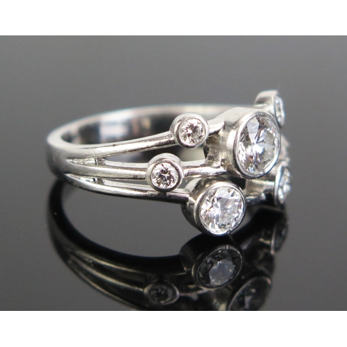 324 - A Platinum and Diamond Seven Stone Ring in rub over settings, largest stone c. 4.8mm, 4mm, 3mm, 2.5m... 