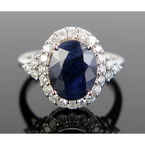 325 - A 14ct White Gold, Sapphire and Diamond Cluster Ring, 17x14mm head, size K.5, c. 3.98g. Sold with in... 