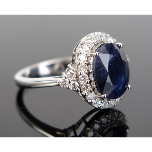 325 - A 14ct White Gold, Sapphire and Diamond Cluster Ring, 17x14mm head, size K.5, c. 3.98g. Sold with in... 