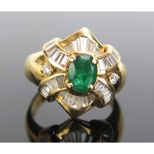 327 - An 18ct Gold, Emerald and Diamond Ring, c. 7x5.3mm emerald, c. 2.8mm baguette cuts and 2 x 2mm round... 