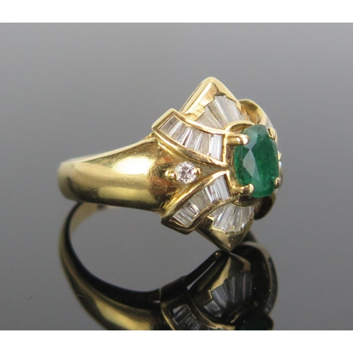 327 - An 18ct Gold, Emerald and Diamond Ring, c. 7x5.3mm emerald, c. 2.8mm baguette cuts and 2 x 2mm round... 