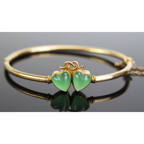 331 - A 15ct Gold and Jadeite? Hinged Bangle decorated with joined hearts, 7.9g